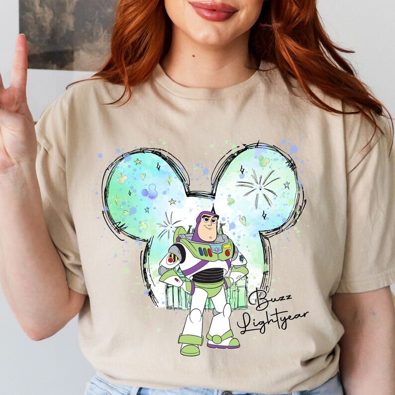 a woman with red hair wearing a mickey mouse shirt