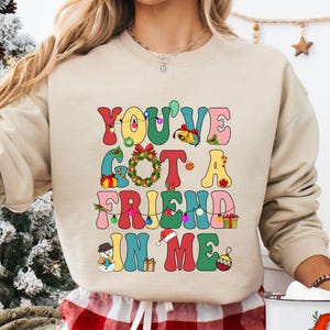a woman wearing a sweatshirt that says you've got a friend in me