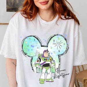 a woman wearing a white shirt with a cartoon character on it