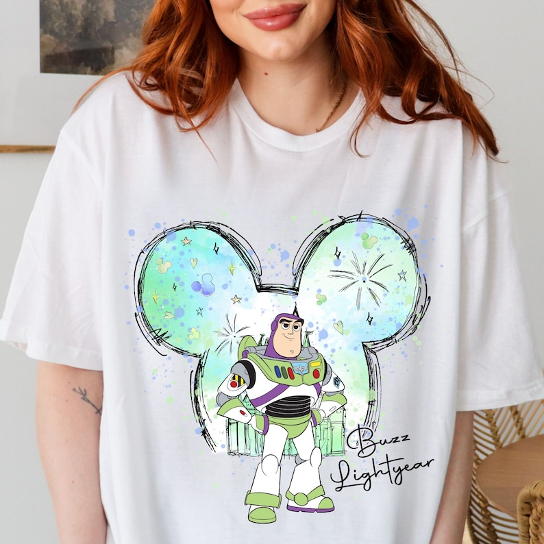 a woman wearing a white shirt with a cartoon character on it