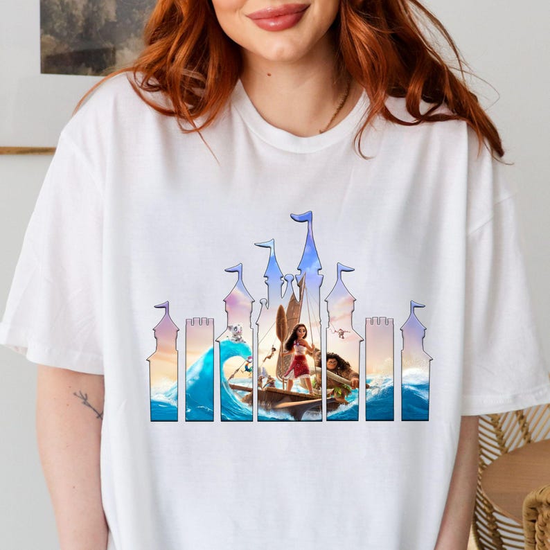 a woman with red hair wearing a white t - shirt with a picture of a