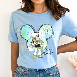 a woman wearing a blue disney mouse shirt
