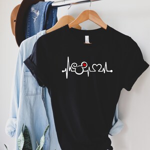 May include: Black t-shirt with a white heartbeat graphic featuring a Mickey Mouse head and a red heart.