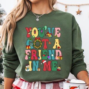 a woman wearing a sweatshirt that says you've got a friend in me