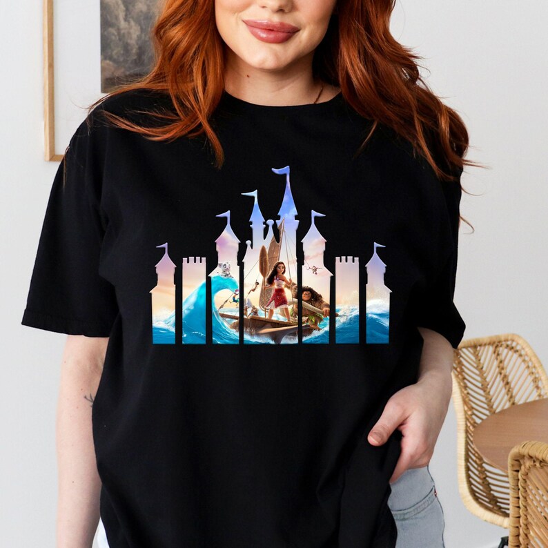 a woman wearing a black t - shirt with a picture of a woman on a