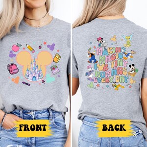 a woman wearing a mickey mouse t - shirt