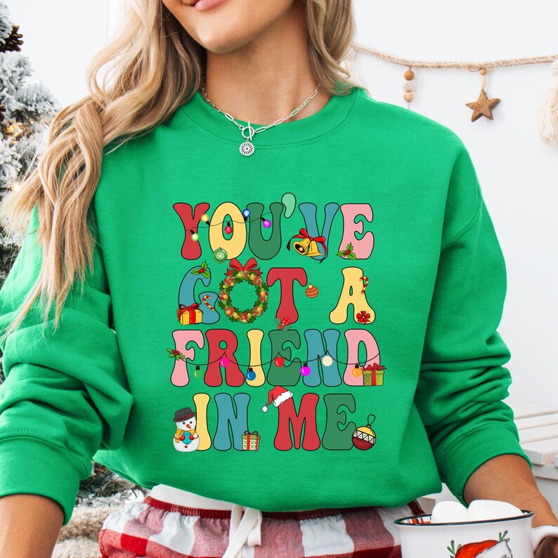 a woman wearing a green sweatshirt that says you've got a friend in me