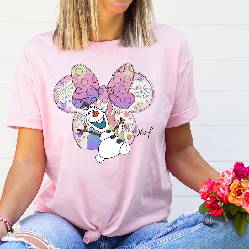 a woman wearing a pink minnie mouse shirt