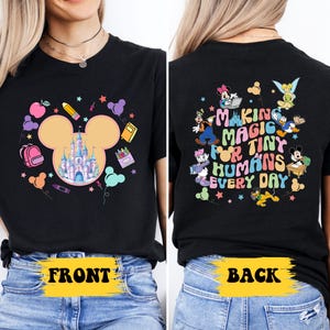 a woman wearing a black mickey mouse shirt