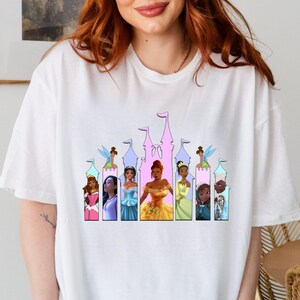 a woman with red hair wearing a disney princess t - shirt