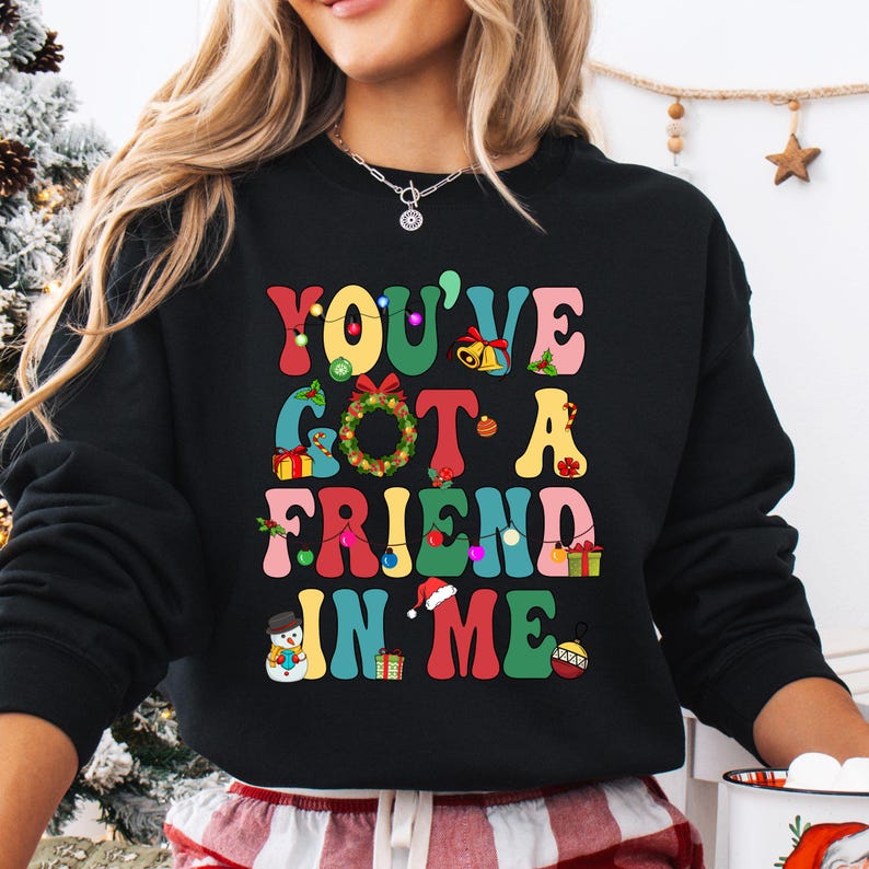 a woman wearing a black sweatshirt that says you've got a friend in me