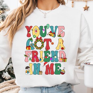 a woman wearing a sweatshirt that says you've got a friend in me