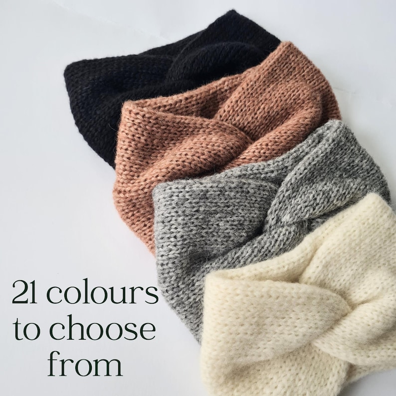 May include: A selection of knitted headbands in shades of black, peach, grey, and cream. The headbands are arranged diagonally. Text in the image reads "21 colours to choose from".