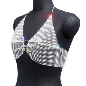 May include: A silver halter top made of a chainmail design with rhinestones. The top has a ring closure at the center.
