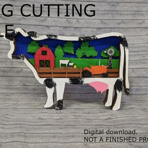 May include: SVG cutting file of a black and white cow with a farm scene inside. The scene includes a red barn, green trees, a tractor, and a windmill.