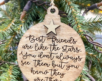 May include: A wooden Christmas ornament shaped like a ball with a star on top. The ornament has the text "Best friends are like the stars. You don't always see them but you know they are there."