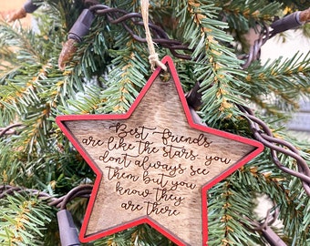 May include: A wooden star-shaped ornament with a red border. The ornament has a message that reads "Best friends are like the stars - you don't always see them but you know they are there."