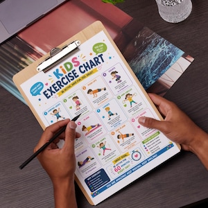 May include: A wooden clipboard with a colorful "Kids Exercise Chart" printed on it. The chart features illustrations of various exercises like jumping jacks, push-ups, and squats. The text encourages kids to be active and have fun. A hand holds a pen, pointing at the chart.
