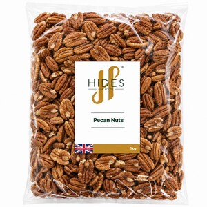 May include: A transparent bag filled with pecan nuts. A white label displays the text "HIDES FINE FOODS" and "Pecan Nuts". The bag also has a Union Jack flag and states "1kg". The pecans are a light brown colour.