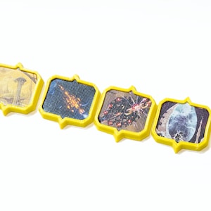 May include: A set of seven yellow picture frames with different images inside. The images include a landscape, a building, a spaceship, a cluster of stars, a skull, a spider, and a close-up of a spider.