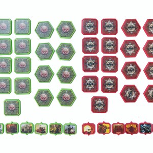 May include: A set of 30 game tokens, 15 green and 15 red. The green tokens are square and feature a green monster face. The red tokens are square and feature a red monster face. The tokens are arranged in rows on a white background.
