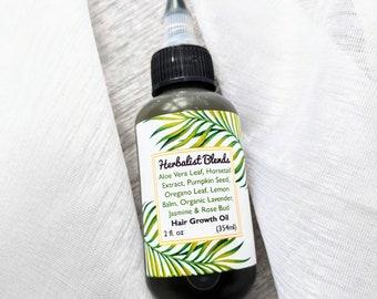 May include: A dark brown glass bottle with a black cap and a white label. The label says "Herbalist Blends" and lists ingredients including aloe vera leaf, horsetail extract, pumpkin seed, oregano leaf, lemon balm, organic lavender, jasmine & rose bud. The label also says "Hair Growth Oil" and "2 fl. oz (354ml)".