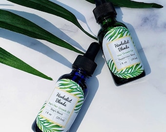 May include: Two small glass bottles with dropper tops, labeled "Herbalist Blends" and containing hair growth oil. One bottle is labeled "Shay's Blend" and the other is labeled "Peppermint Blend". Both bottles are 1 fl. oz (29.5 ml).