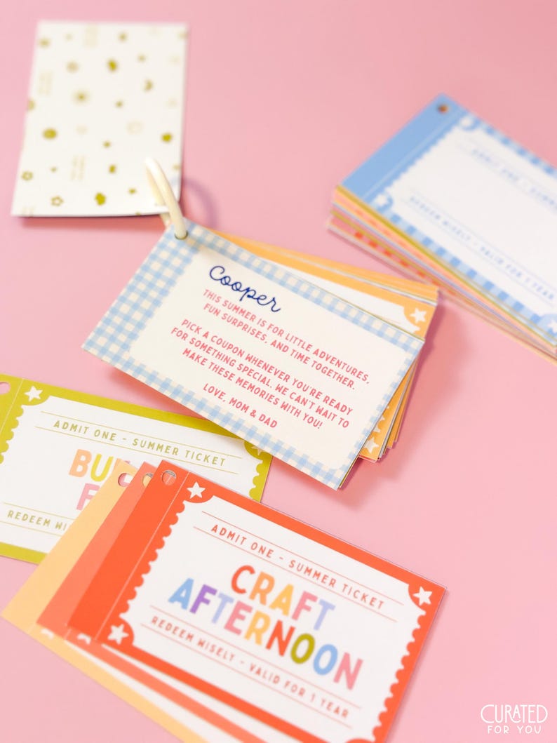 May include: A set of colorful rectangular paper tickets held together by a white plastic ring. The tickets feature various designs, including blue gingham patterns and red borders with stars. Text includes "Cooper," "Admit One," and "Craft Afternoon."