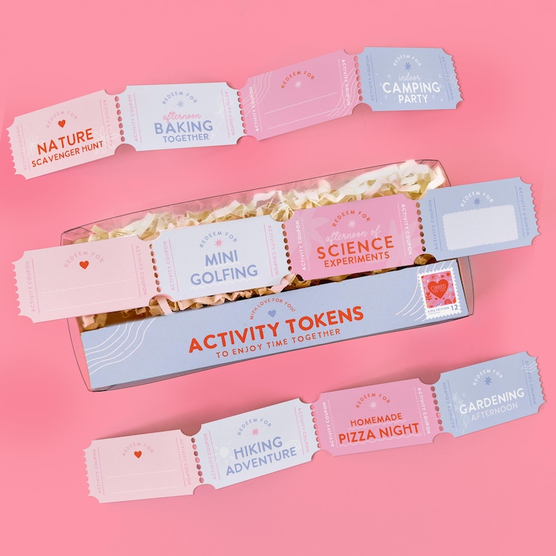 May include: A set of activity tokens in a box, with a pink background. The tokens are light pink and blue, with phrases like "Nature Scavenger Hunt" and "Camping Party". The box reads "Activity Tokens to Enjoy Time Together".