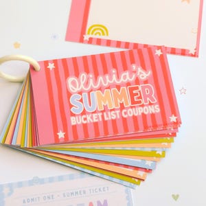 May include: A set of rectangular paper coupons bound by a white plastic ring. The cover features pink vertical stripes, white stars, and the text Olivia's SUMMER BUCKET LIST COUPONS. Additional loose cards show pastel colors and text including ICE CREAM DATE.