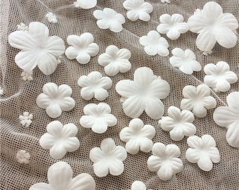 May include: White fabric with a mesh texture and 3D white flower embellishments.
