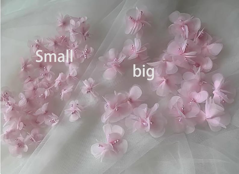 May include: Pink fabric flowers with pearl accents, labeled "small" and "big" on a white tulle background.