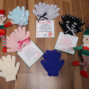 May include: An assortment of children's gloves in various colors, including blue, pink, gray, and black, with text such as "Sparkle Magic Glove" and "Elf's Magic Glove." The gloves are paired with elf dolls and handwritten notes from Santa.