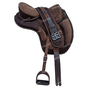 Puede incluir: Una silla de montar de cuero marrón con un asiento de malla negra y paneles de gamuza marrón. La silla tiene un estribo y una cincha.