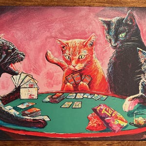 May include: A rectangular mat featuring a poker game with four cats. The cats, in shades of black, orange, and black and white, are gathered around a green poker table. Cards, chips, and snacks are visible. The background is pink.