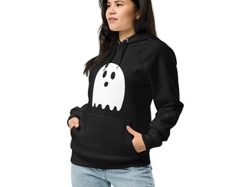 May include: Black hoodie with a white ghost graphic on the front. The ghost has three black oval eyes and a wide open mouth. The hoodie has a drawstring hood and a front pocket. The person is wearing blue jeans.