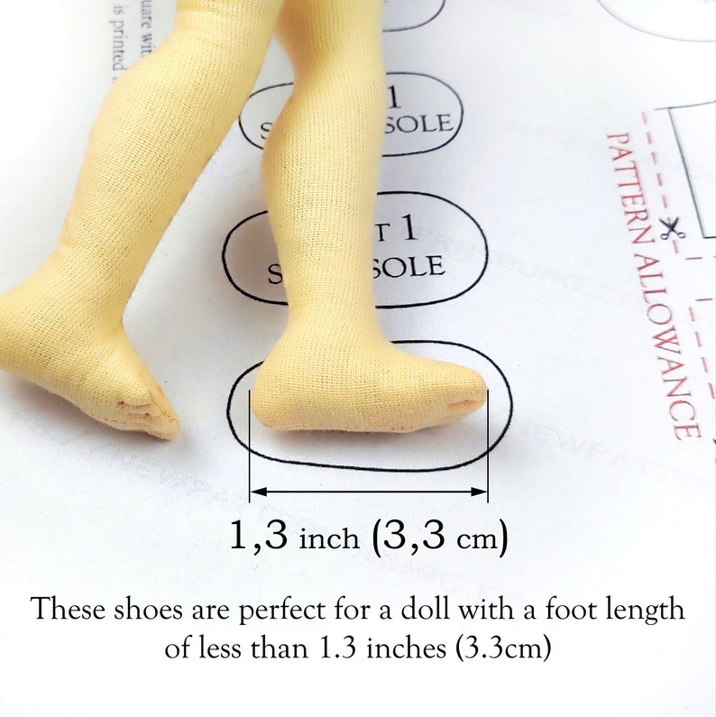 May include: Close-up of doll legs with light yellow fabric shoes. The foot length is measured at 1.3 inches (3.3 cm). The text states these shoes are for a doll with a foot length of less than 1.3 inches.