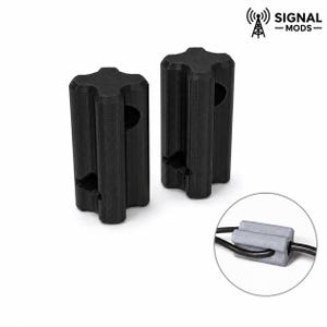 May include: Two black, star-shaped signal mods. The mods are cylindrical with a hole in the center and a slot at the bottom. A close-up shows a gray ferrite bead with two black wires.