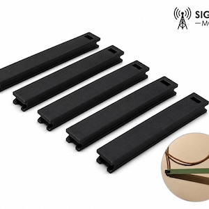 May include: Five black rectangular components with a textured surface are arranged diagonally. Each has a rectangular cutout at one end. The Signal Mods logo is in the upper right corner. A small, circular graphic is in the lower right.