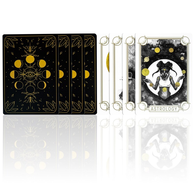 Card backs show the moon phases, an evil eye and crystals in gold over a black background. The oracle card deck front shows a woman of color, black girl juggling planets in her hands. She is a planetary witch and looks like the Black Sailor Moon