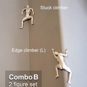 May include: A set of two white wall-mounted climber figures. One figure is labeled Stuck climber, positioned in an inner corner. The other is labeled Edge climber (L), positioned on an outer corner. The text Combo B 2 figure set as shown is visible.
