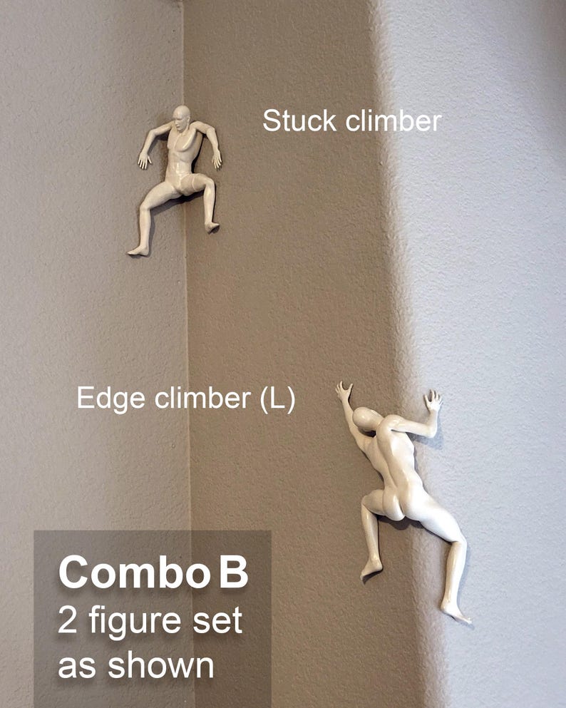 May include: A set of two white wall-mounted climber figures. One figure is labeled Stuck climber, positioned in an inner corner. The other is labeled Edge climber (L), positioned on an outer corner. The text Combo B 2 figure set as shown is visible.