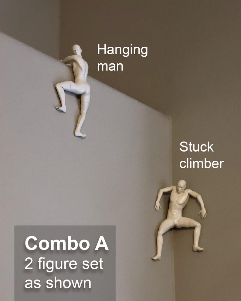 May include: A set of two off-white wall-mounted figurines. One figure is labeled 'Hanging man' and is positioned over a ledge. The second figure is labeled 'Stuck climber' and is positioned in a corner. The set is labeled 'Combo A 2 figure set as shown'.