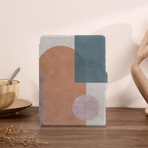 May include: A rectangular case with an abstract geometric design. The design features a large, rust-colored semi-circle, a square of muted blue, and a smaller, pale purple circle. The background is a light gray with a textured, distressed appearance.