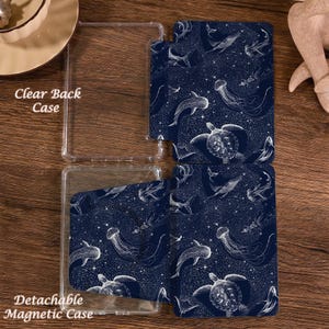 May include: A clear back case and a detachable magnetic case featuring a dark blue pattern of white line-art sea creatures including whales, jellyfish, and sea turtles against a starry background. The text Clear Back Case and Detachable Magnetic Case are visible.