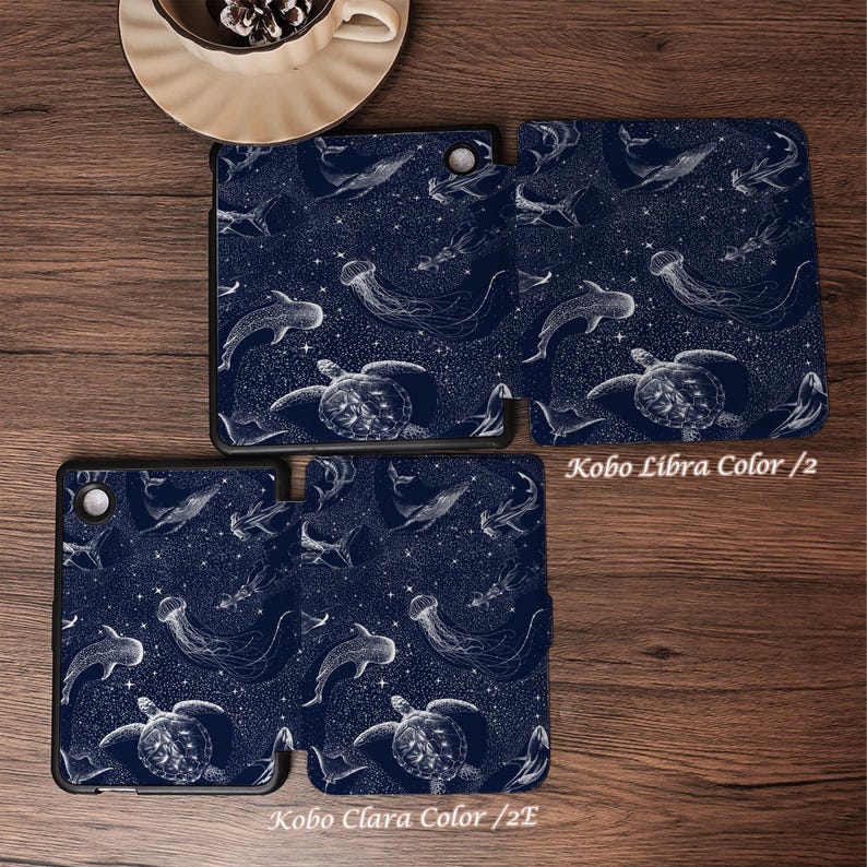May include: Two dark blue e-reader cases featuring a white line art pattern of sea turtles, jellyfish, and whales against a starry background. The text Kobo Libra Color /2 and Kobo Clara Color /2E is printed near the respective device cases.
