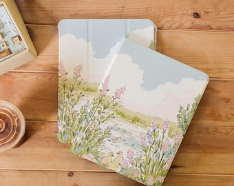 May include: Two tablet cases with a watercolor design of a pond with ducks and flowers. The cases are light blue and white with a soft, pastel color scheme.
