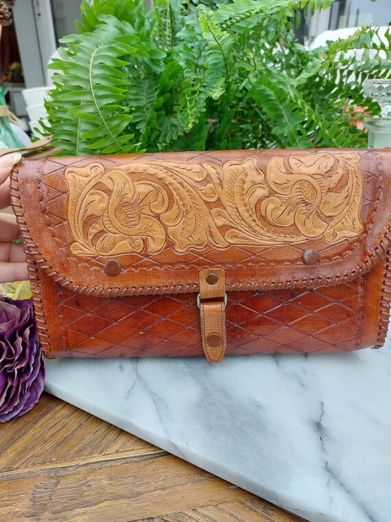 Gorgeous vintage hand tooled leather cross body clutch, with red velvet lining and beautiful patina