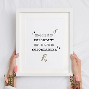 May include: White framed print with the text "English is important but math is importanter" with a book and pencil icon.