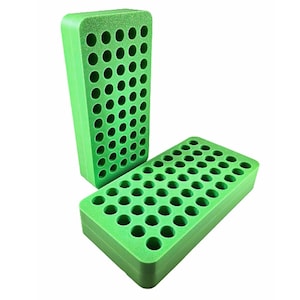 May include: Two bright green foam blocks with multiple circular holes. One block is upright, and the other is lying flat. The blocks appear to be made of a dense, porous material, possibly for organizing small items.